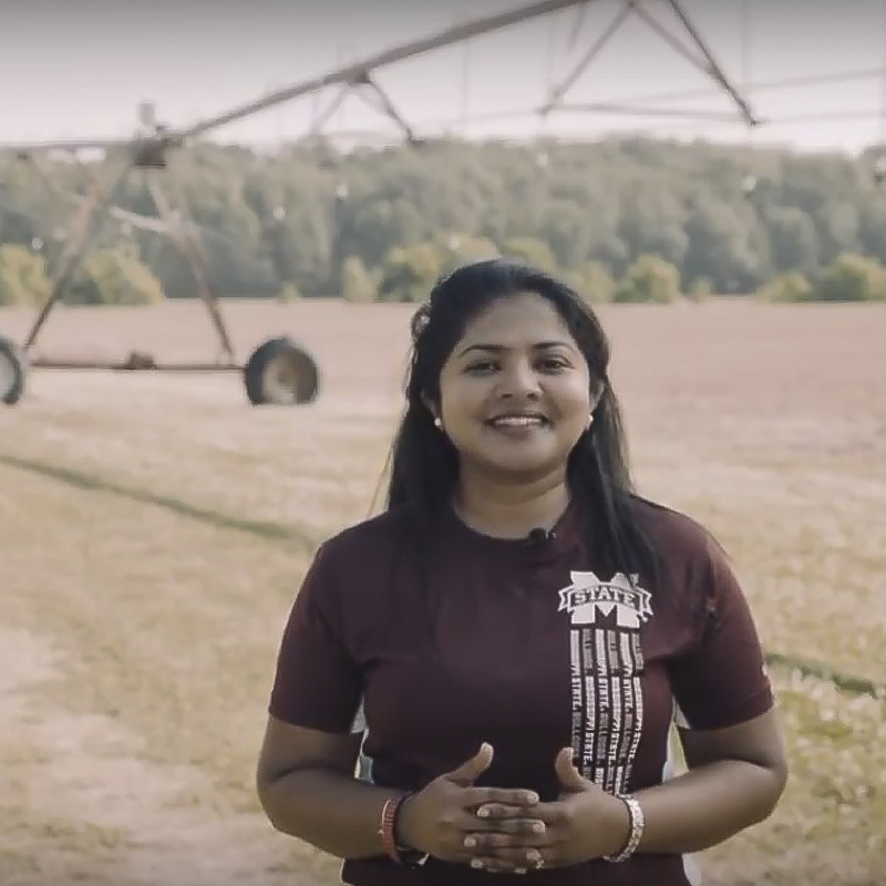 Chathu standing in field.