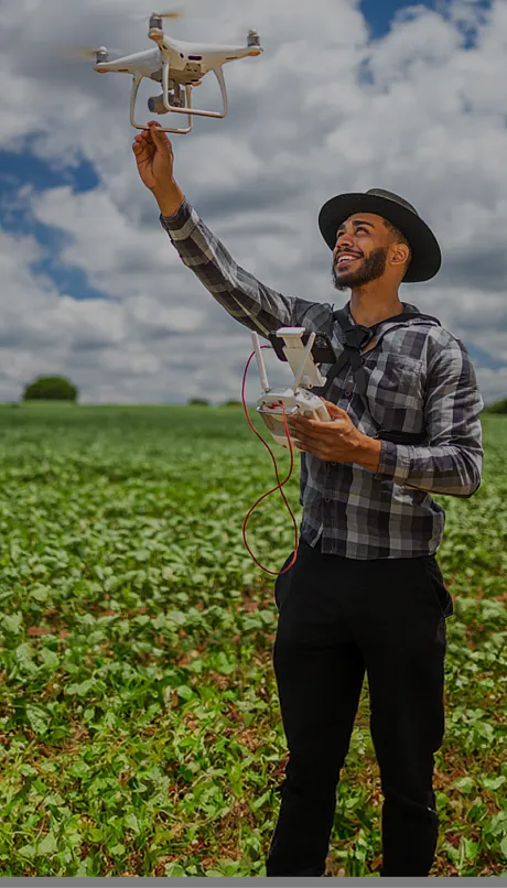 Man using a drone in a crop field